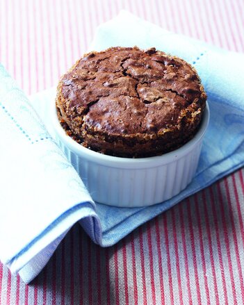 Auf dem Foto ist ein Schokoladen-Lebkuchen-Soufflé zu sehen. Das Förmchen steht auf einer blauen Serviette. | © SONNENTOR